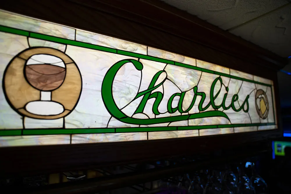 The stained-glass Charlie's sign above the bar
