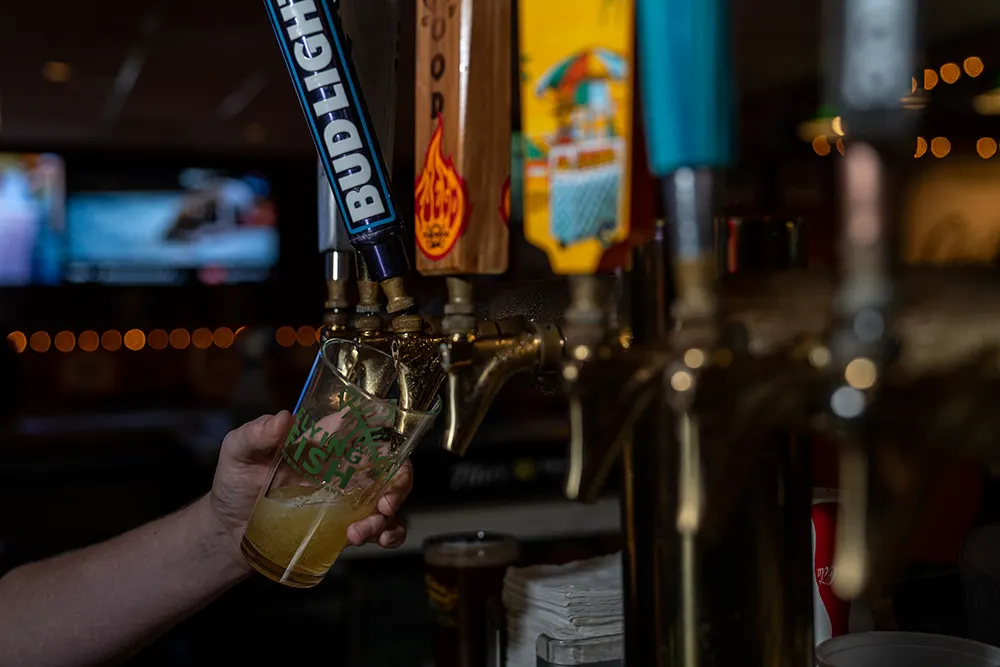 A Charlie's pint held up at the tap wall